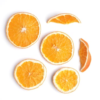 Dried orange fruit slices on a white background, food or Christmas concept, high resolution image