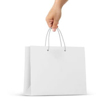 Hand holds a paper bag on a white background