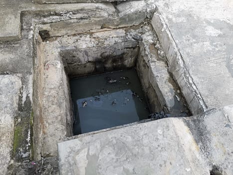 Manhole cover open in street and repair of roads. Accident with sewer hatch in city. Concept of sewage, underground utilities