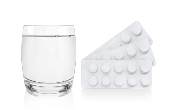 Package of pills and a Glass of Water. Pharmacy and medicine concept