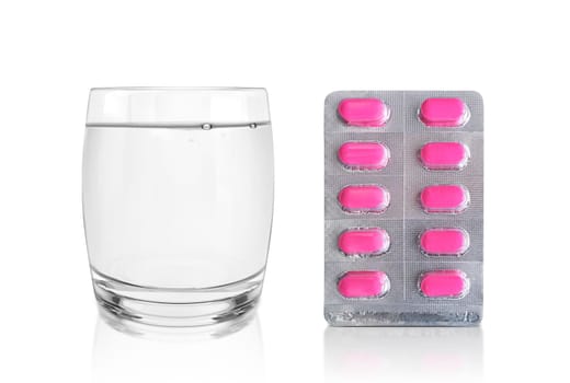 Package of pills and a Glass of Water. Pharmacy and medicine concept