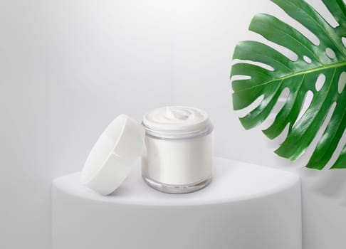 Whitening cream in a package. on a white pedestal with light entering through the and tropical plants, 3D render for cosmetic advertisements