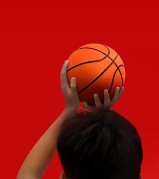 Hands and basketball isolated on red background