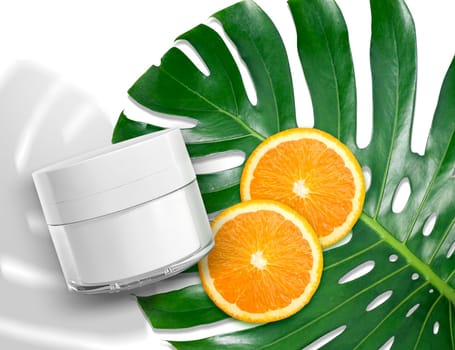Luxury skin care product ad, top view of blank packaging clear glass jar of beauty cosmetic cream with monstera leaf and oranges