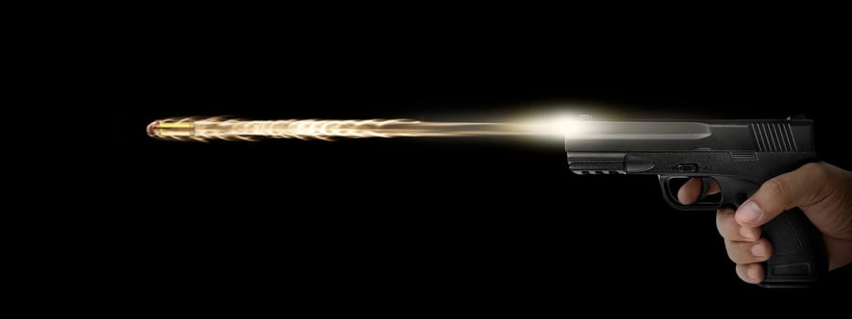 The hand presses the trigger of the gun and the flame from the shot escapes from its muzzle