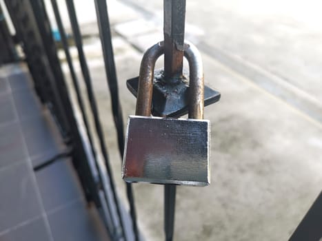 Old Locked Padlock Hanging On The Old Fashioned Metal Gate