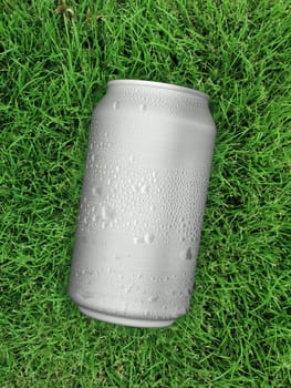 Top view. of Aluminum can with water droplets on grass green