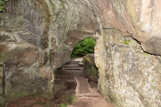 Huel Lee or Hohllay on the Mullerthal trail in Luxembourg, open cave with view to the forest, sandstone rock formation