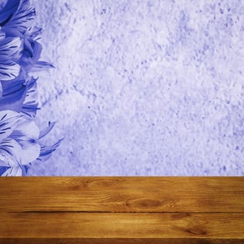 Background flowers on a textured stucco wall and blank wooden planks in the foreground. For product demonstrations, free space, layout, mockup, perspective board, background board.