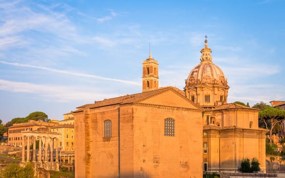 ROME, ITALY - CIRCA AUGUST 2020: sunrise light with blue sky on Roman ancient architecture.