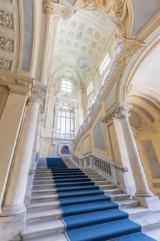 TURIN, ITALY - CIRCA JUNE 2021: The most beautiful Baroque staircase of Europe located in Madama Palace (Palazzo Madama). Interior with luxury marbles, windows and corridors.
