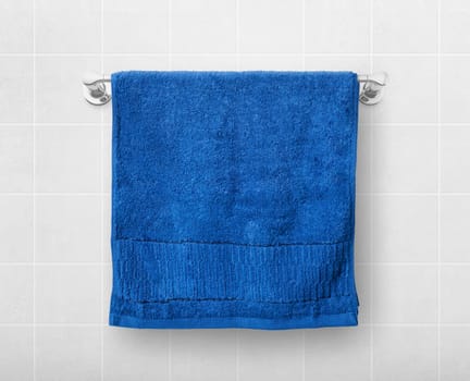 A blue towel hangs on a hanger rod.