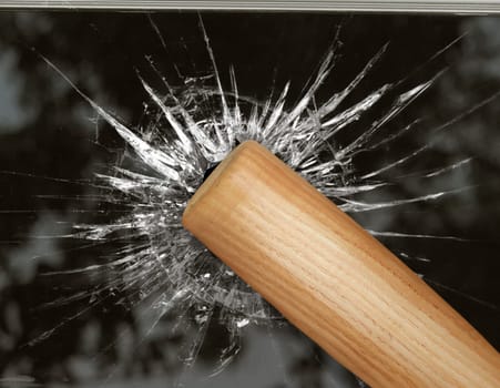 Baseball bat hits through broken glass