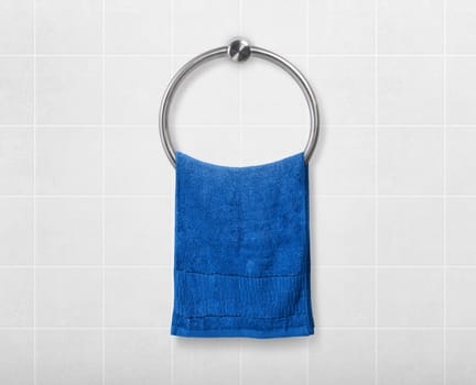 Blue hand towel hanging on hanger in toilet bathroom