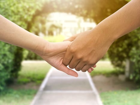 Image of a couple holding hands in a park