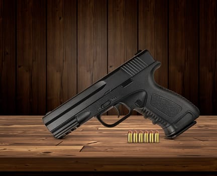 gun with bullets on wooden background