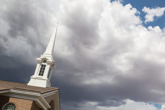 Church Steeple Tower Below Ominous Stormy Thunderstorm Clouds.