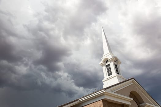 Church Steeple Tower Below Ominous Stormy Thunderstorm Clouds.