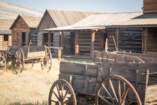 Abstract of Vintage Antique Wood Wagon and Log Cabins.