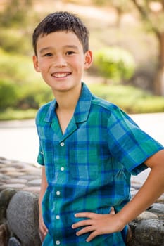 Outdoor portrait of a biracial Chinese and Caucasian boy.