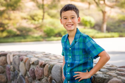 Outdoor portrait of a biracial Chinese and Caucasian boy.