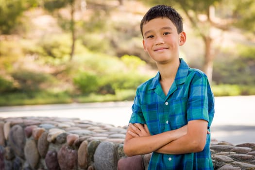 Outdoor portrait of a biracial Chinese and Caucasian boy.