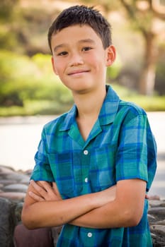 Outdoor portrait of a biracial Chinese and Caucasian boy.