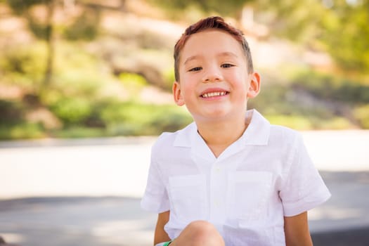 Outdoor portrait of a biracial Chinese and Caucasian boy.