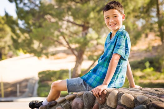 Outdoor portrait of a biracial Chinese and Caucasian boy.