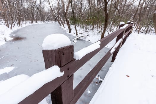 Rustic Bridge Over Frozen River In Winter.