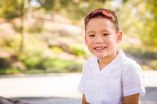 Outdoor portrait of a biracial Chinese and Caucasian boy.