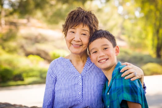 Outdoor portrait of a biracial Chinese and Caucasian boy and his Chinese Grandmother.