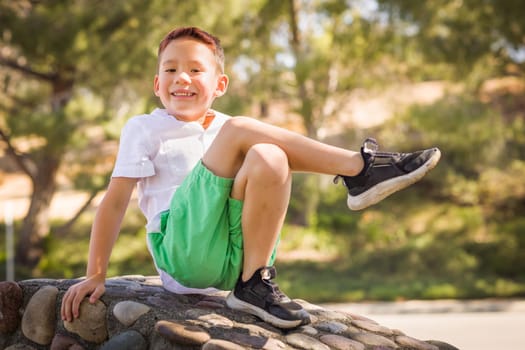 Outdoor portrait of a biracial Chinese and Caucasian boy.