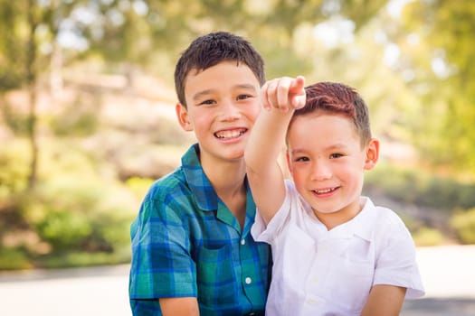 Outdoor portrait of biracial Chinese and Caucasian brothers.