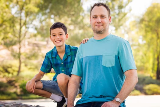 Outdoor portrait of biracial Chinese and Caucasian father and son.
