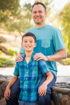 Outdoor portrait of biracial Chinese and Caucasian father and son.