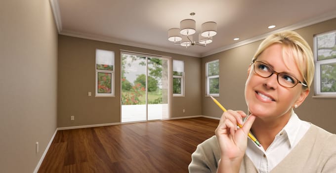 Creative Woman with Pencil Contemplating Empty Room of House.