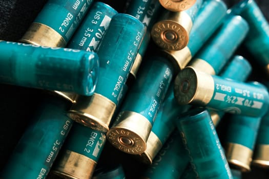 Shotgun shells on a black surface. Ammunition for 12 gauge smoothbore weapons. Hunting ammunition. Dark background