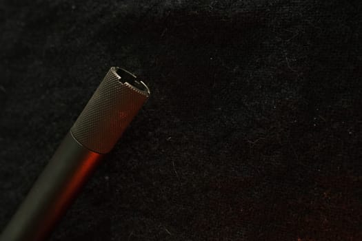 Muzzle of shotguns. Shotgun - macro shooting. Muzzle end of the barrel on a black cloth background. Hunting rifle.