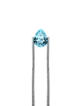 blue diamonds held in tweezers on a white background