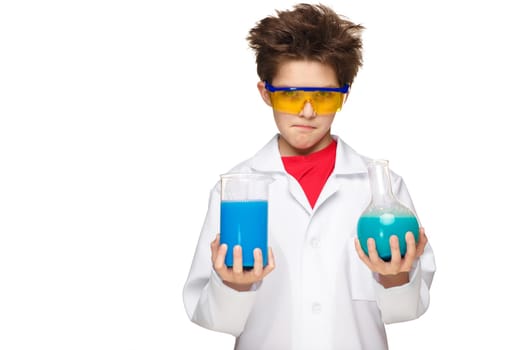 Little boy in a white coat as chemist doing experiment with multicolored chemical fluid in the laboratory isolated on white background