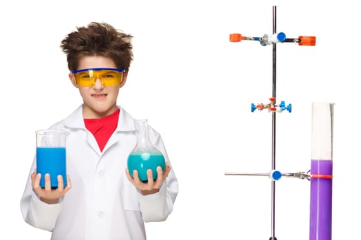Little boy in a white coat as chemist doing experiment with multicolored chemical fluid in the laboratory isolated on white background