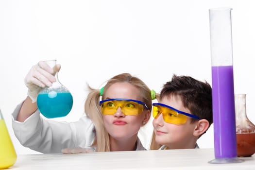 Teen and teacher of chemistry at chemistry lesson making experiments isolated on white background