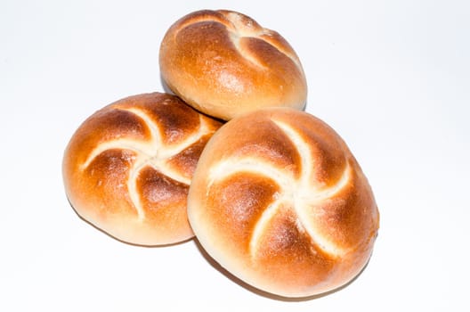 Three crisp fresh buns against a white background.