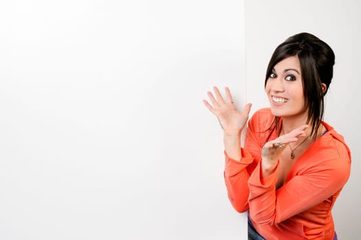Very excited woman stands next to blank white space