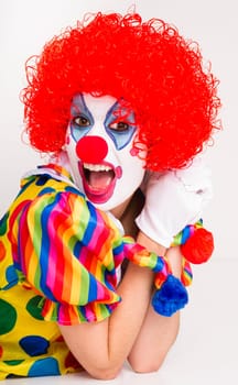 Colorful female clown actress speaking out
