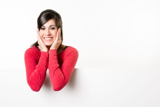 Woman smiles at she stands in between white spaces