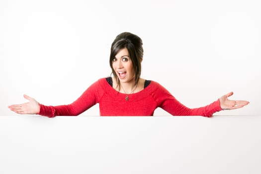 Woman smiles at she stands in between white spaces