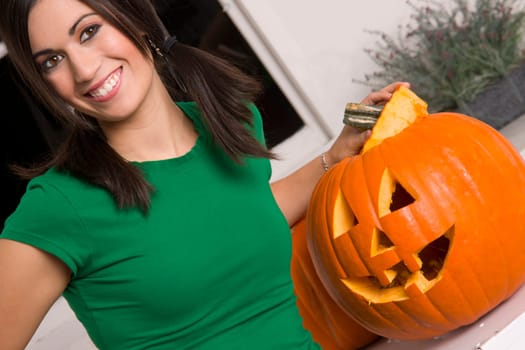 Joyful Woman at Halloween with Orange Carved Pumpkin