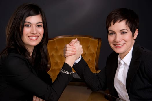 Female Business Associates Arm Wrestling